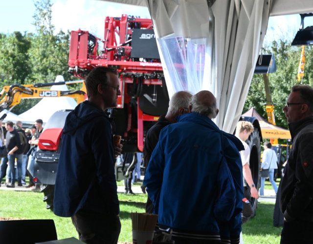 People talking together at an outdoor event.