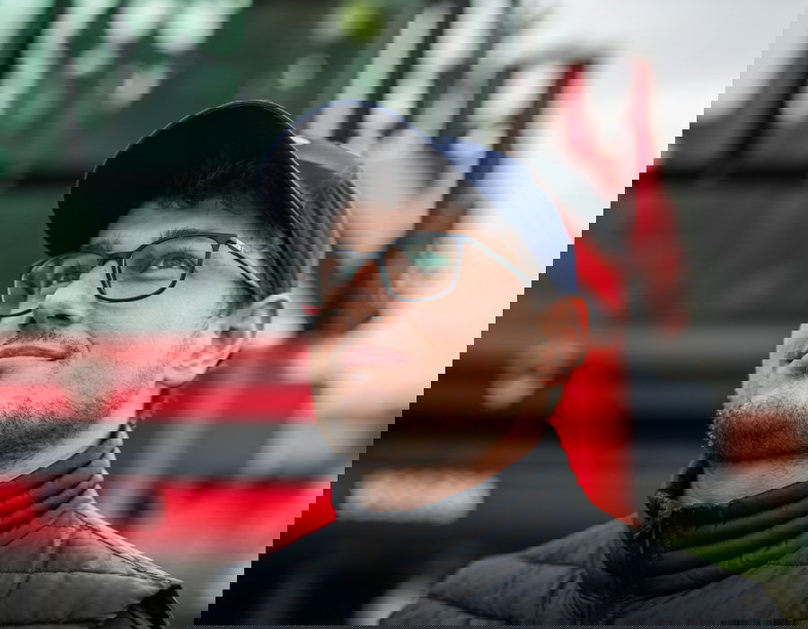 Man looking into the distance in front of his Agrifac sprayer.