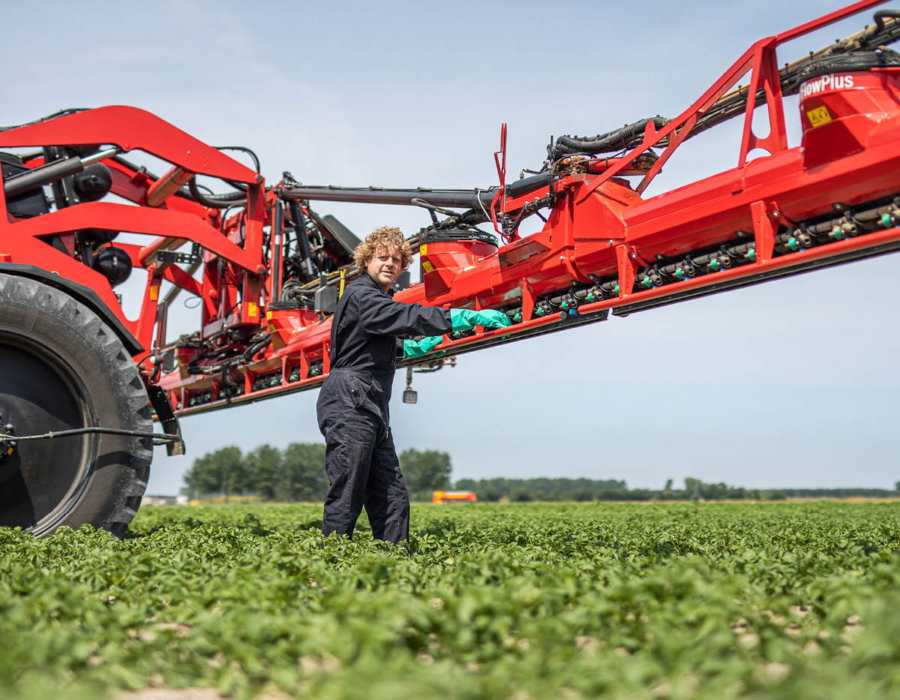 An Agrifac sprayer with AirFlowPlus boom and a man standing next to it.