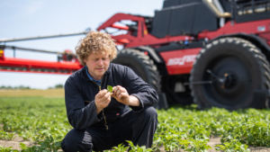 Frank de Schutter inspecting his crops in front of his Agrifac Condor WideTrack