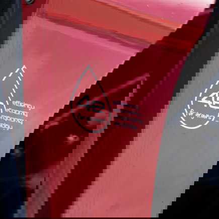 Close up of a red Agrifac sprayer with a prominent slogan sticker on the body.