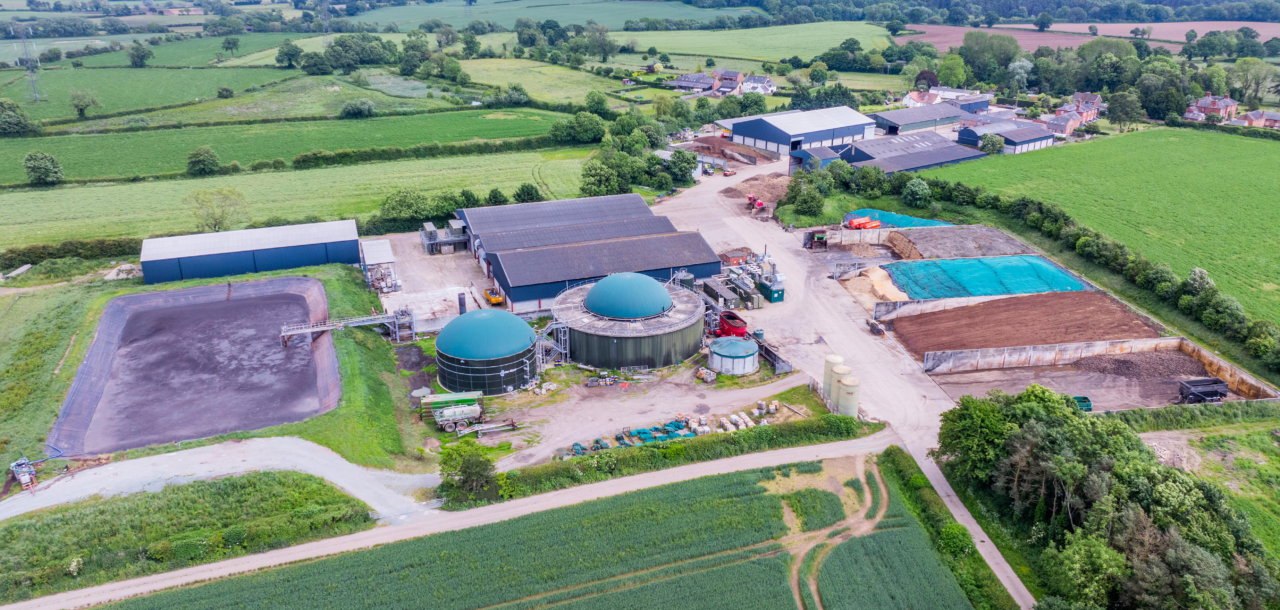 Aerial view of a farm surrounded by fields and agricultural land.