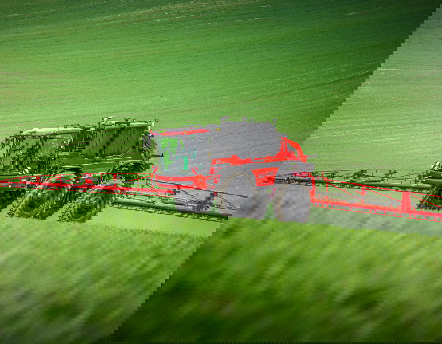 The Agrifac Condor MountainMaster actively spraying in a green field. The machines showcases how it can easily operate in hilly areas.