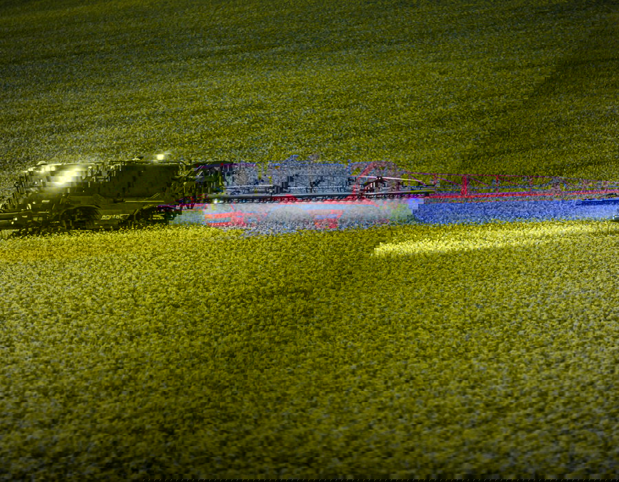 Condor Clearance operating in a field with lights on.