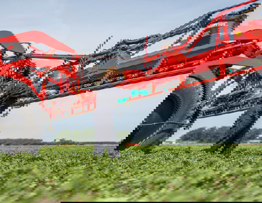 An Agrifac sprayer with AirFlowPlus boom and a man standing next to it.