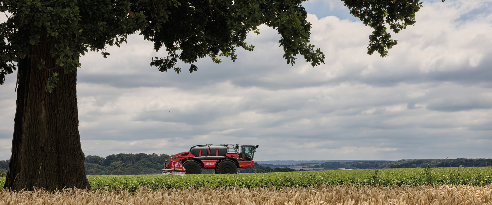 Agrifac sprayer spraying in a green field.