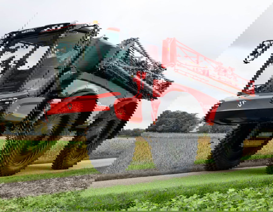 Stationary Vanguard 67 on the road with the boom folded.