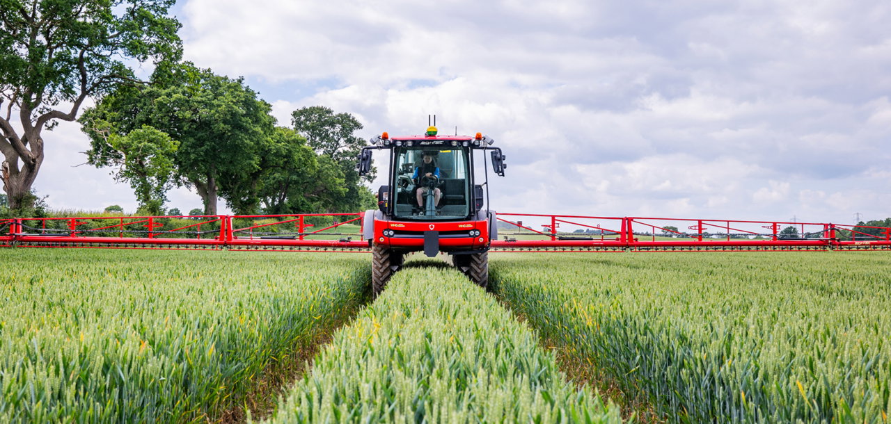 Agrifac Condor Vanguard sprayer spraying in a green landscape.
