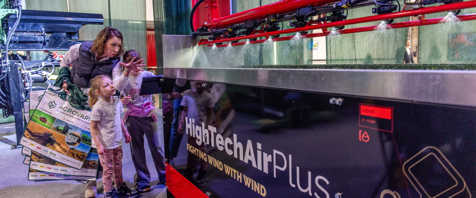 Woman and children looking at a demonstration setup.