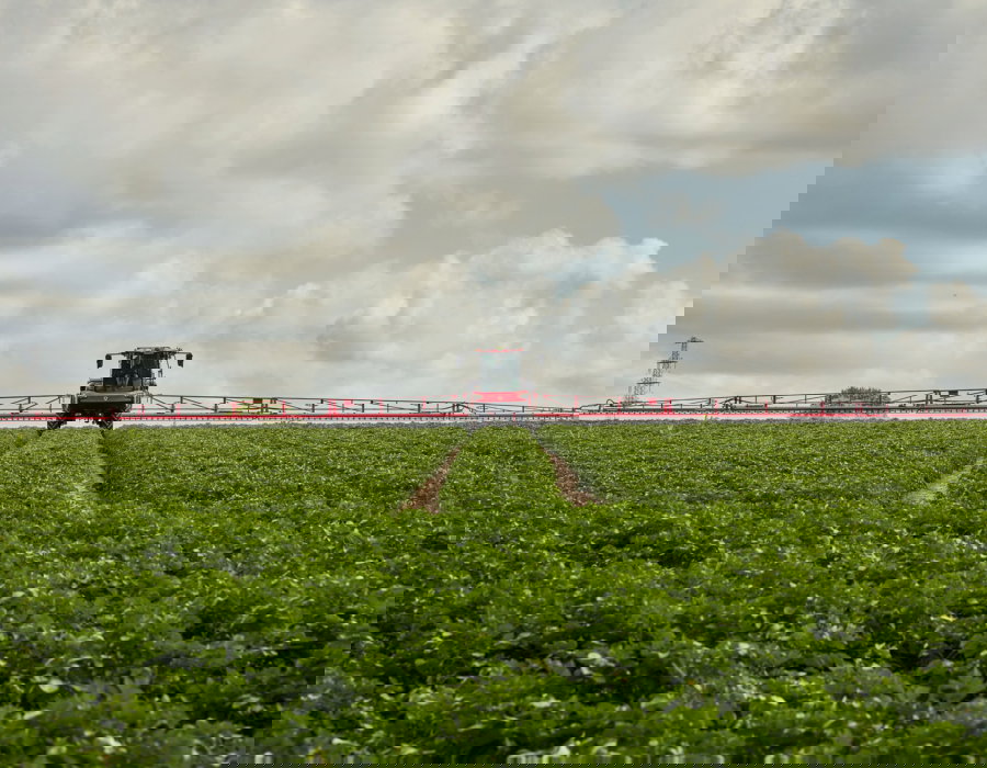 Agrifac sprayer positioned in a field, front view.